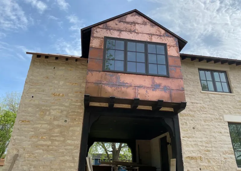 Copper metal panel facade on a stone building for Roof Repair in West Whittier-Los Nietos